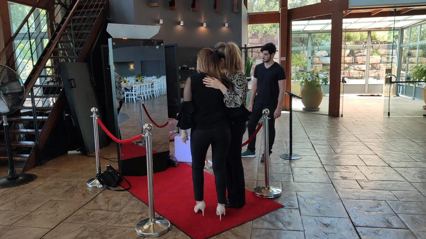 LED-framed mirror photo booth set up at a New York City event venue