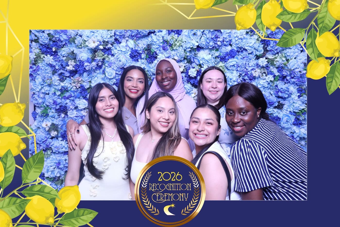 Seven colleagues smiling at the blue flower wall — 2026 Recognition Ceremony print